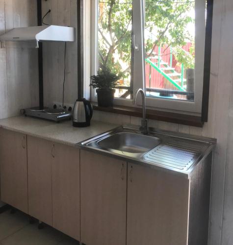 a kitchen with a sink and a window at Мини-отель Sunrise-Bugaz in Zatoka