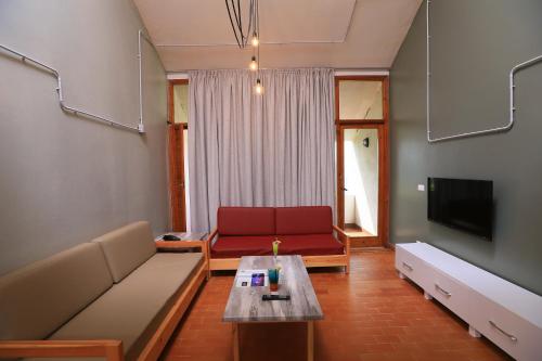 a living room with a couch and a table at Cimer SafraMarine Beach Resort in Safra