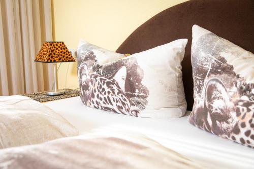 a bed with two pillows with a cat on it at B&B Fischerstüble - adults only in Hagnau