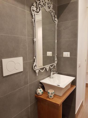a bathroom with a sink and a mirror at Vatican Room and Kitchen in Rome