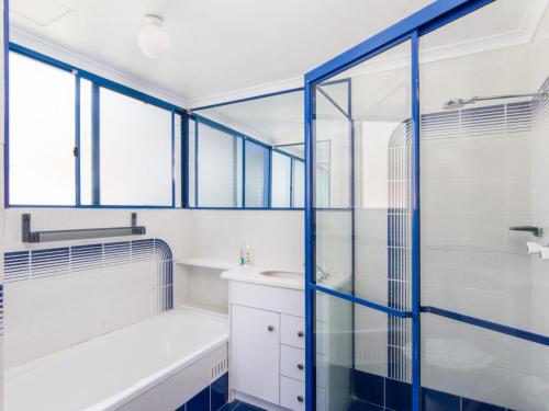 a bathroom with a tub and a sink and a shower at Heritage 202 in Tuncurry