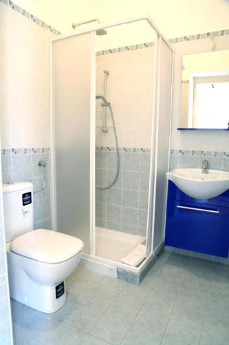 a bathroom with a toilet and a shower and a sink at Bed & Breakfast Duomo Di Taormina in Taormina