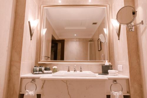 a bathroom with a sink and a mirror at The Imperial, New Delhi in New Delhi