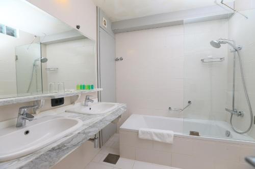 a white bathroom with two sinks and a shower at Cimer SafraMarine Beach Resort in Safra