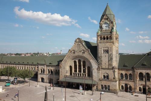 a large stone building with a clock tower at Alerion Centre Gare in Metz