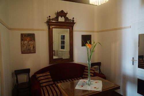 a living room with a couch and a vase on a table at Somborski salas - strogi centar in Sombor