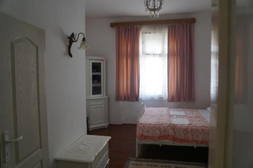 a small room with a table and a window at Somborski salas - strogi centar in Sombor
