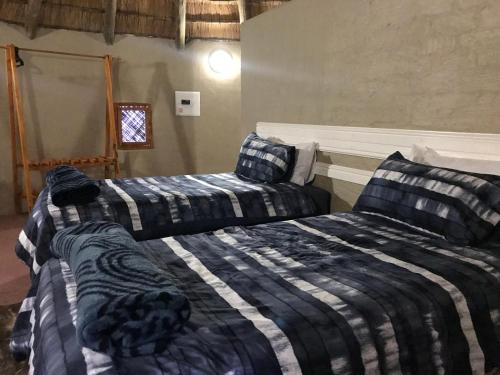 two beds sitting next to each other in a bedroom at Kwakunje Guest Lodge in Dundee