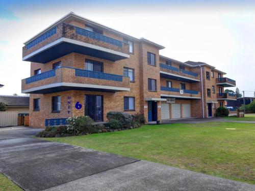 a brick apartment building with blue balconies on it at Seabreeze 6 in Tuncurry