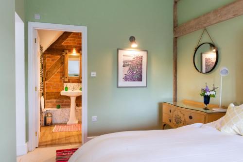 A bed or beds in a room at The Hayloft, Wall End Farm