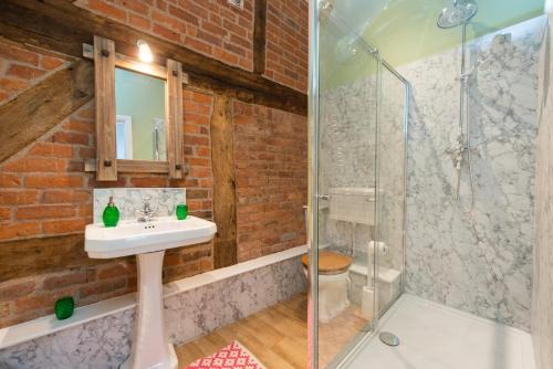 a bathroom with a sink and a shower at The Hayloft, Wall End Farm in Leominster