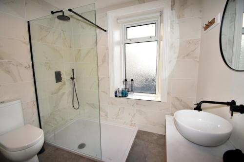 a bathroom with a shower and a toilet and a sink at The Promenade, Portstewart in Portstewart