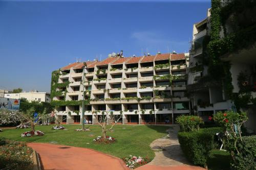 an apartment building with a garden in front of it at Cimer SafraMarine Beach Resort in Safra