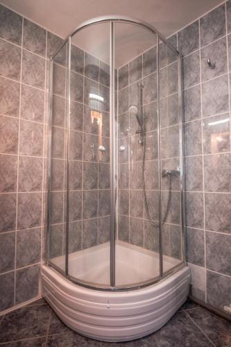 a shower with a glass door in a bathroom at Hotel Cristal in Jupiter