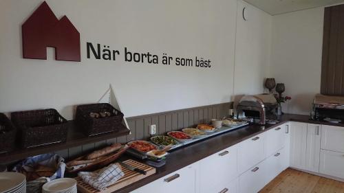 a kitchen with many different types of food on a counter at Marsfjäll Mountain Lodge Hotell i Saxnäs in Saxnäs