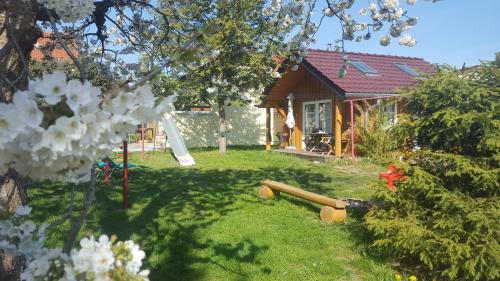 a backyard of a house with a yard with a playground at Ferienwohnung Niesky in Niesky