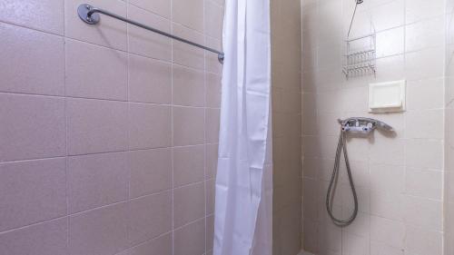 a shower with a shower curtain in a bathroom at Vacancéole - Résidence Les Gorges Rouges in Guillaumes