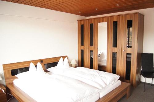 a bedroom with two beds and a mirror at Hotel-Restaurant Sonne in Talheim