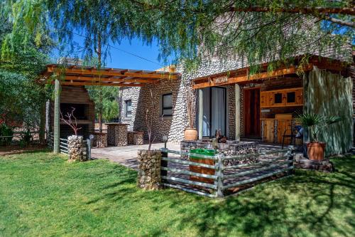 a house with a porch and a patio at Kalahari Camelthorn Guesthouse and Camping in Askham