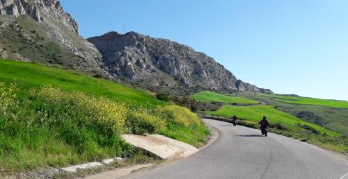 two people riding motorcycles down a road in the mountains at Cortijo Los Maximos in Turón