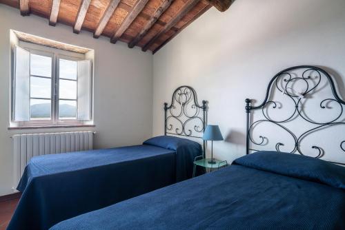 Postel nebo postele na pokoji v ubytování Accogliente alloggio con vista e piscina