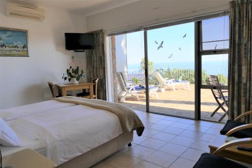a bedroom with a bed and a view of a patio at Guest House Michelitsch in Cape Town