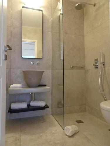 a bathroom with a shower and a sink and a mirror at enJOY the sea and relax in Mikonos