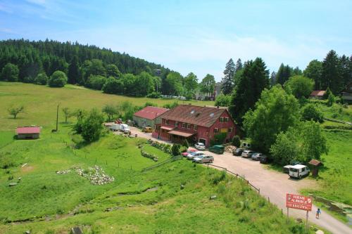 eine Luftansicht eines Hauses mit Autos auf einem Feld in der Unterkunft Gîtes du Kreuzweg in Le Hohwald