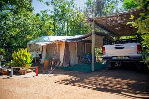 a white truck parked in front of a tent at Kalahari Camelthorn Guesthouse and Camping in Askham