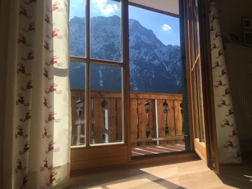 an open window with a view of a mountain at ALPENFREUND in Mittenwald