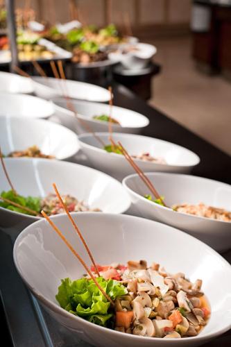 a row of white bowls of food on a table at Akka Antedon Hotel - Premium Ultra All Inclusive in Beldibi