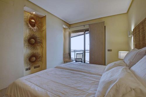 a bedroom with two beds and a window with a view at La Sal in Tazacorte