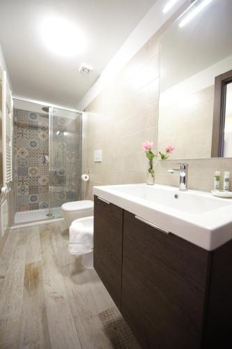 a bathroom with a white sink and a toilet at Cascina Cortese in Druento