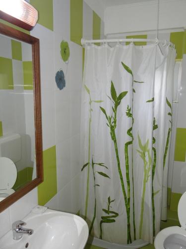a bathroom with a shower curtain with bamboo at Belvedere in Corbeni