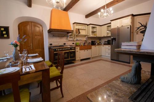 a kitchen with a table and a dining room at Villa Rina Deluxe and Cottage in Porto Ceresio