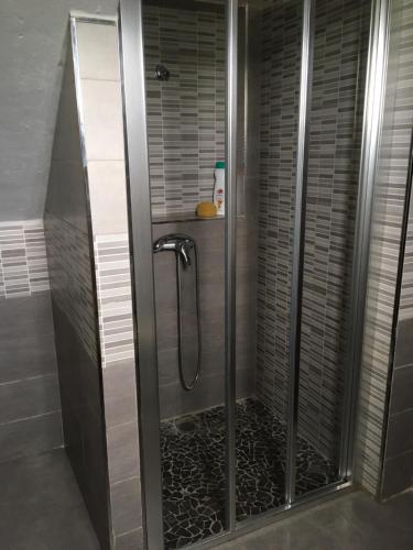 una ducha con puerta de cristal en un baño en Casa Baños, en Manilva