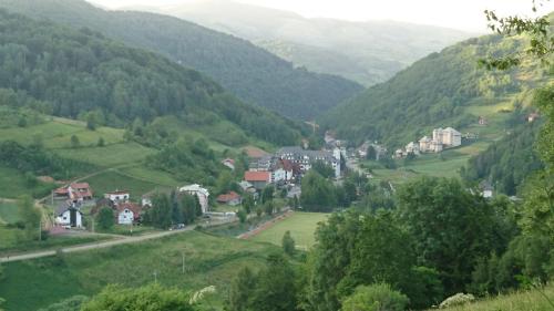 a small town in a valley with green hills at GOski Apartman Brzeće Kopaonik in Brzeće