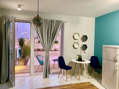 a kitchen with a table and chairs and a refrigerator at Deluxe Suites Mandić in Omiš