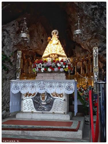 anointing altar in a church with flowers and lights at Casa de Aldea La Xunta in Cangas de Onís