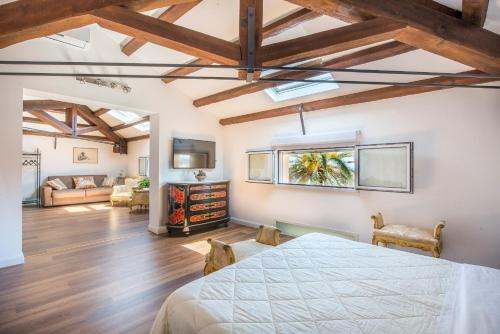 a room with a bed and a living room at B&B Villa Liberty sul mare in Palermo