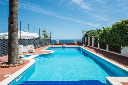 a swimming pool with a view of the ocean at B&B Villa Liberty sul mare in Palermo