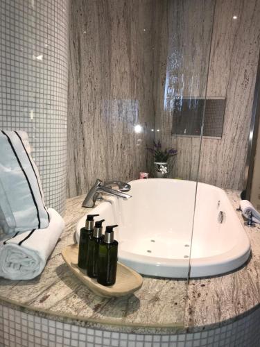 a bathroom with a tub and a sink at Melia Valencia in Valencia