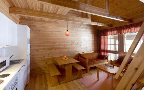 a kitchen with a table and a chair in a room at Koivula Cottages in Jämsä