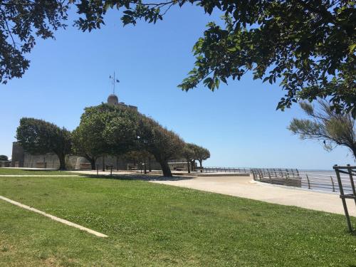 a building with a cross on top of it next to the water at Petit nid à 50m de la plage au coeur de Fouras in Fouras