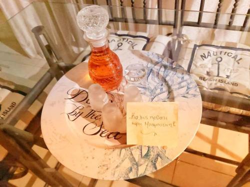 a bottle of honey on a table with a sign at Eretria houses in Eretria