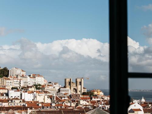 a view of a city from a window at Dear Lisbon - Palace Chiado Suites in Lisbon