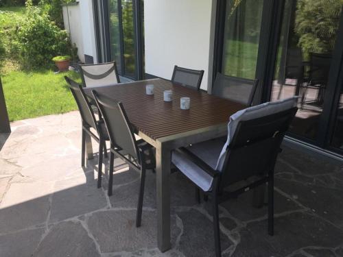 a wooden table and chairs on a patio at Appartement Elzerland in Mayen