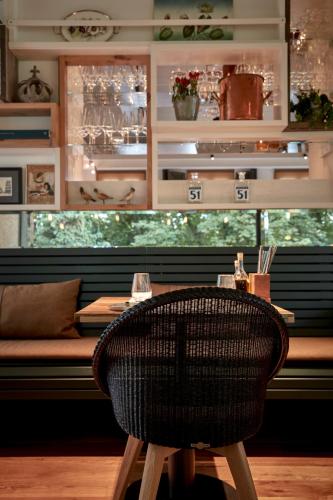a wicker chair sitting at a table in a restaurant at LA MAISON hotel & spa in Saarlouis
