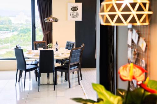 a dining room with a table and chairs at Cozy Living Sky Apartment in Kota Kinabalu