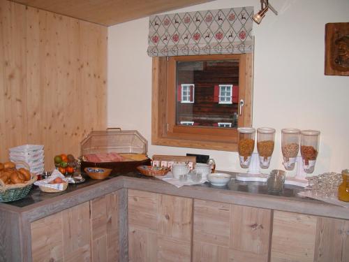 a kitchen with a counter with some food on it at Pension Alpenperle in Holzgau